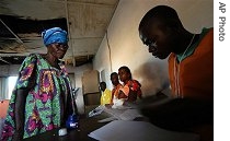 An election worker processes voters at a polling station in Bumba in Congo's Equatorial province, Sunday, Oct. 29, 2006