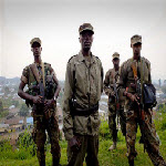 Colonel Sultani Makenga, center, a senior M23 leader, on a hill in eastern Congo, July 2012
