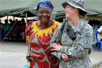 U.S. Army Maj. Angie Allmer assists a Congo resident to the medical waiting area in Kinshasa