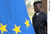 A policeman of UPI (Integrated Police Unit) stands in front of an EU flag on eve of second round presidential election campaign, Oct. 13, 2006, in Kinshasa