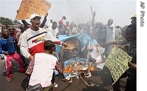 Opposition party supporters burn a poster of President Joseph Kabila during a rally at the city of Kinshasa, Tuesday