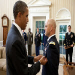President Barack Obama presents White House Military Aide LTC Barrett Bernard with the Defense Superior Service Medal during a departure ceremony in the Oval Office, Oct. 12, 2011.
