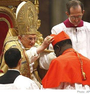 Newly-elevated Cardinal Laurent Monsengwo Pasinya, of the Democratic Republic of Congo, receives the red three-cornered biretta hat from the Pope during a consistory inside St. Peter's Basilica, at the Vatican, 20 Nov 2010 
